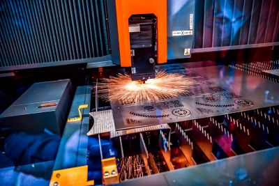 CNC Laser cutting of metal, modern industrial technology. Small depth of field. Warning - authentic shooting in challenging conditions.