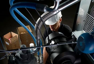 Mechanic with helmet changing parts compressor
