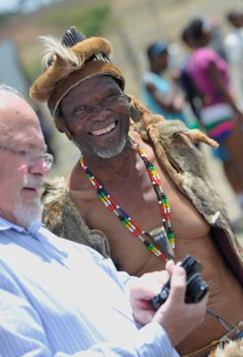 Happy old man looking into the camera