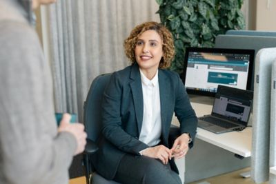 Employees discussing something at a desk. 