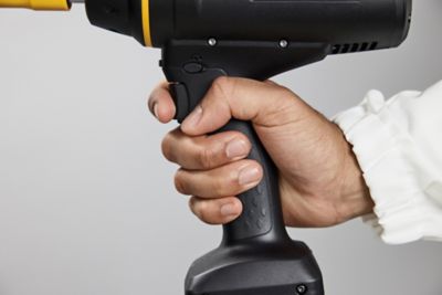 IPBP held by a hand that is pushing one finger on the trigger