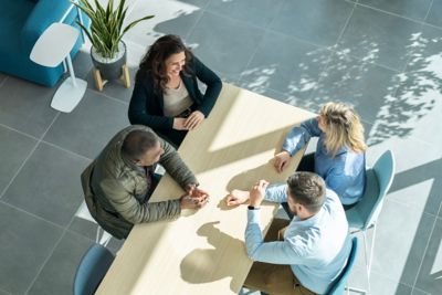 A diverse group of employees amidst a discussion at a table