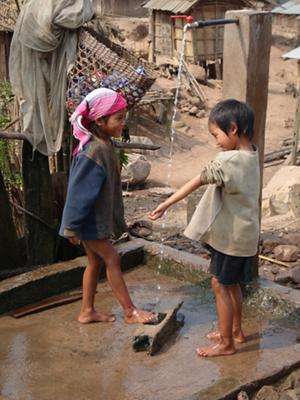 Children playing with water in Laos