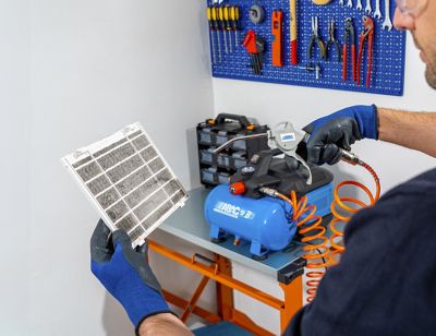 ABAC Air Blow Gun - Man cleaning air conditioner filters in the workshop_squared