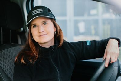 A woman service technician setting behind the wheel of an Atlas Copco service van