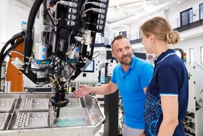 Customer and service technician with adhesive dispensing system in production