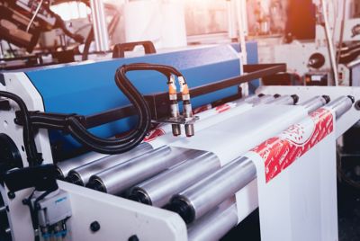 Modern automated production line in factory. Plastic bag manufacturing process. Background