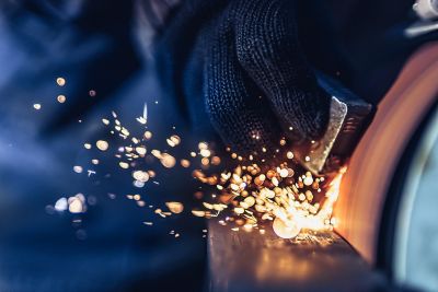Closeup of Sparks that fly out when grinding metal details machine. Metallurgical Plant. 
