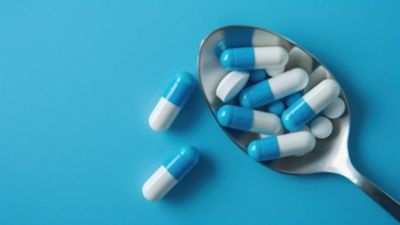 A set of green medication getting packaged