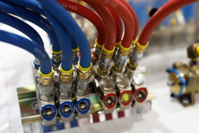 Reinforced rubber air hoses with pneumatic fittings. Selective focus.