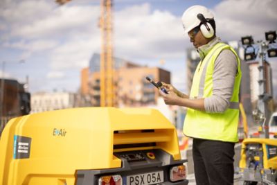 Application expert testing sound levels on construction site