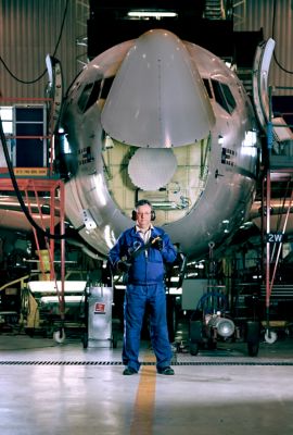 Worker standing in front of airplane with LSF12 die grinder in hand
