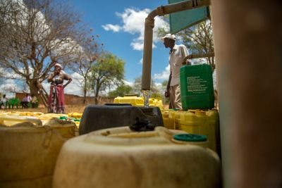 Woman and man by water kiosk