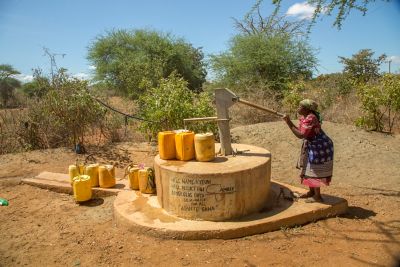Woman pumping water