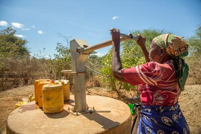 Woman in Kenya pumping water