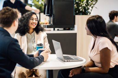 Employees having an engaging discussion in a casual meeting, fostering teamwork and communication.
