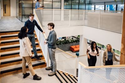 Professional employees interacting at a workplace. This image captures social office setting with collaborative teamwork.