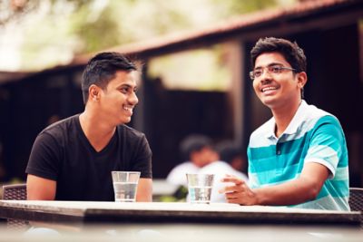 Two men interacting outside office hours in India.