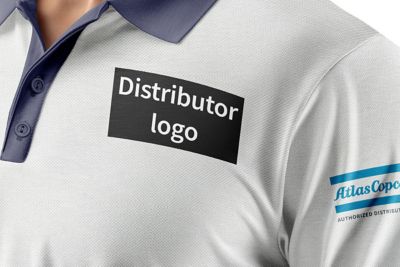 A mock-up photo close-up of a white polo shirt with Atlas Copco authorized distributor featured on a sleeve and position of distributor's own logo shown on the chest