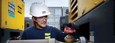 Atlas Copco employee working with a rental tool