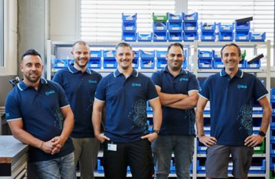 Group of employees posing in the storage area