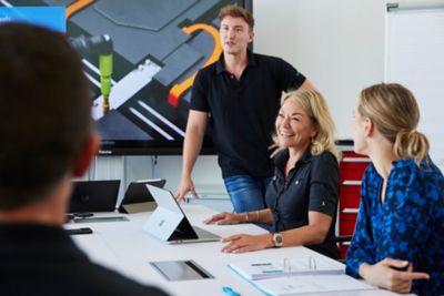 Employees in the middle of a discussion in a meeting room