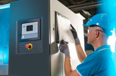 Service Technician changing filter in cubicle
