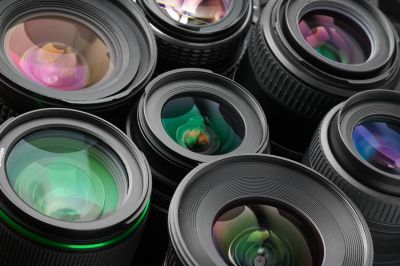 Close-up of many various photo lenses with colorful antireflection multi-layer coating.