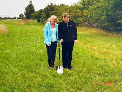 DANMIL founders with a shovel in the ground, marking the ceremonial start of a new chapter.