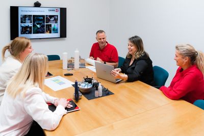 Team members from DANMIL interacting in a meeting