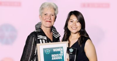 Two women smiling at awards ceremony