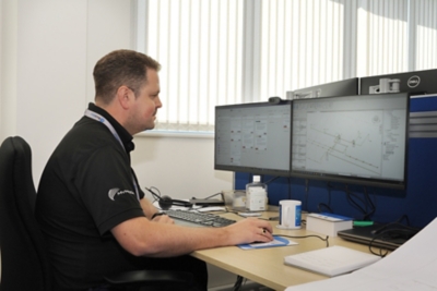 Man in office working on designs on hiss computer