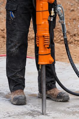 Image of an orange APT tool using a dust suppression kit