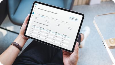 A person using a tablet showing Atlas Copco software