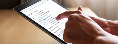 A person searching the web for "Atlas Copco" on a tablet