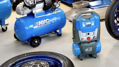 Direct drive piston compressors range in garage with tyres