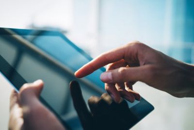 hands using tablet with windows on the back ground