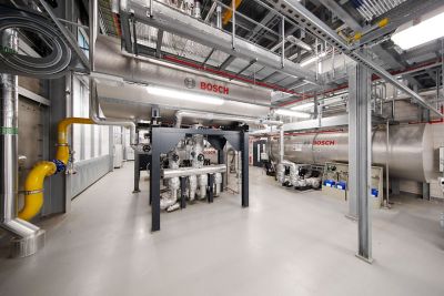 Industriebereich mit mehreren großen Dampfkesseln von Bosch, umgeben von Edelstahlrohren, Ventilen und technischen Installationen.