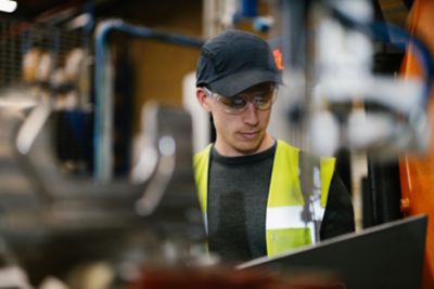 Employee looking at a computer in a workshop environment