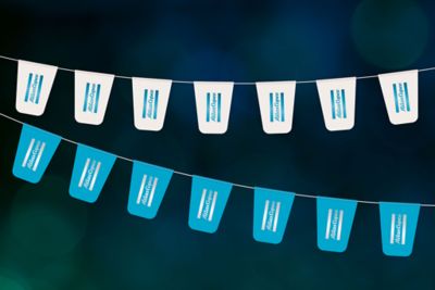 Blue and white Atlas Copco flags hanging from the ceiling with a vertical logo