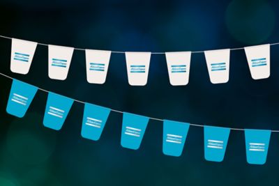 Blue and white Atlas Copco flags hanging from the ceiling