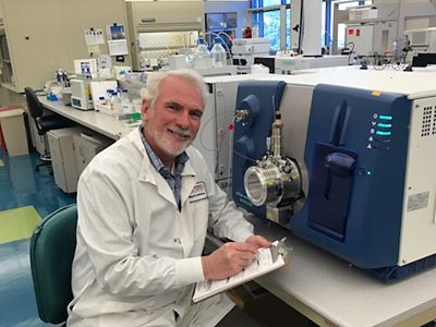 FS Medical environmental monitoring technician sits in front of monitoring equipment.