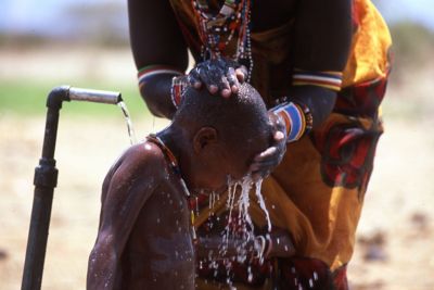 Boy cleaning up by the water tap