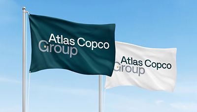 Two Atlas Copco Group  flags in teal and white backgrounds 