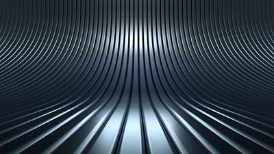 Metallic surface rendered with radial blur effects, creating a spinning or vibrating illusion. The effect blends light and shadow with cool steel tones.