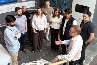 Eight students are listening to Atlas Copco employee talking about tools