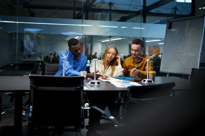 Colleagues working on low-carbon technologies at office desk. 