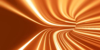 Abstract orange light streaks forming curved lines and motion trails on a dark background, suggesting speed, energy and fluid movement.