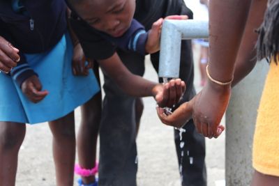 Children drinking from the well - closeup