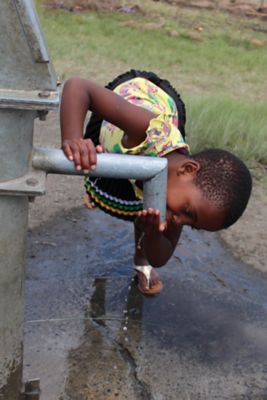 Girl drinking from the well